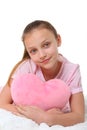 Happy girl with pink heart pillow Royalty Free Stock Photo