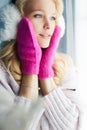 Happy girl in pink mittens and fur hat