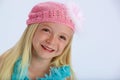 Happy girl in pink woollen hat