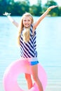 Happy girl play swim ring at the beach