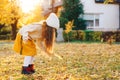 Happy girl playing with autumn leaves. Happy child walking and having fun in fall backyard