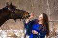 Happy girl playing with horse, horse shows teeth, closeup portrait