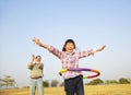 Happy girl playing hula hoops Royalty Free Stock Photo