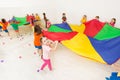 Happy girl playing parachute game with her friends Royalty Free Stock Photo