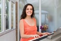 Happy girl playing synthesizer at home Royalty Free Stock Photo