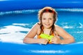 Happy girl playing with water gun in the pool Royalty Free Stock Photo