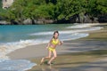 Happy girl plays in sea on tropical beach Royalty Free Stock Photo