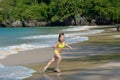 Happy girl plays in sea on tropical beach Royalty Free Stock Photo