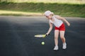 Happy girl plays tennis on court outdoors Royalty Free Stock Photo