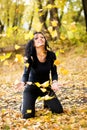 Happy girl pleying with yellow leaves Royalty Free Stock Photo