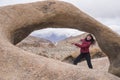 Happy girl pointing to an arch in the beautiful formations of Alabama Hills Royalty Free Stock Photo