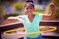 Happy girl, portrait and playing with plastic hoop at park for fun game, activity or outdoor exercise. Young teenager or Royalty Free Stock Photo