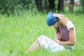 happy girl reading a book on the nature of the Bible in the Park Royalty Free Stock Photo