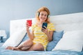 Happy girl reading news on smartphone at home, weekend. Relaxed woman. Weekend relax Royalty Free Stock Photo