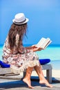 Happy girl reading during tropical white beach Royalty Free Stock Photo