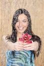 Happy girl with red orchid under water drops