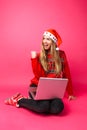 Happy girl in red sweater and Santa hat, excited about the good Royalty Free Stock Photo