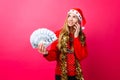 Happy girl in red sweater and Santa hat, talking on phone and ho Royalty Free Stock Photo