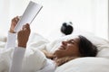 Happy girl relax in bed reading interesting book Royalty Free Stock Photo