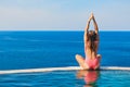 Woman at edge of infinity swimming pool with sea view Royalty Free Stock Photo