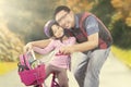 Happy girl riding a bike with dad Royalty Free Stock Photo