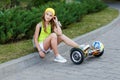 A pretty happy girl riding on hover boards or gyroscooters outdoors at sunset in summer. Active life concept