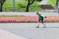 Happy girl roller skates on sunny city square Royalty Free Stock Photo
