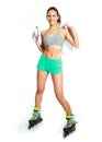 Happy girl with rollerskates drinking water Royalty Free Stock Photo