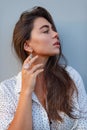 Happy girl with rose quartz ring and mother of pearl earring showing off her jewelry Royalty Free Stock Photo