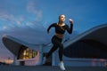 Happy girl run outdoor at modern urban area during sunset. Royalty Free Stock Photo