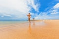 Happy girl run by wide sand beach Royalty Free Stock Photo