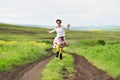 Happy girl running on a countryside road Royalty Free Stock Photo