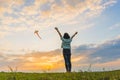 Happy girl running with a kite at sunset outdoors Royalty Free Stock Photo