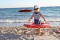 Happy girl in sailor hat on beach Royalty Free Stock Photo