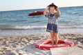 Happy girl in sailor hat on beach Royalty Free Stock Photo