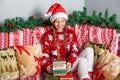 Happy Girl in Santa Claus Hat Opens a Christmas Gift Box With Present Inside Royalty Free Stock Photo