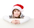 Happy girl in santa hat with Christmas candy cane standing behind banner. isolated on white Royalty Free Stock Photo