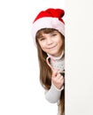 Happy girl in santa hat with Christmas candy cane standing behind banner on white Royalty Free Stock Photo