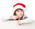 Happy girl in santa hat with Christmas candy cane standing behind white banner. isolated on white Royalty Free Stock Photo