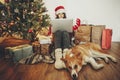 Happy girl in santa hat shopping online on laptop and sitting wi Royalty Free Stock Photo