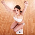 Happy girl on scales. Weight-loss. Royalty Free Stock Photo