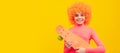 Happy girl scater with orange hair in pink poloneck smile holding pennyboard, skateboarding. Funny teenager child on Royalty Free Stock Photo