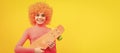 Happy girl scater with orange hair in pink poloneck smile holding pennyboard, skateboarding. Funny teenager child on Royalty Free Stock Photo