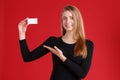 Happy girl, showing a blank business card and smiling. Royalty Free Stock Photo