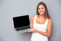 Happy girl showing blank laptop screen Royalty Free Stock Photo