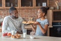 Happy girl showing dad freshly baked croissants Royalty Free Stock Photo