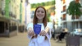 Happy girl showing passport before camera, adulthood, step into adult life