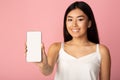 Happy girl showing phone empty screen to camera