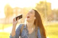 Happy girl singing listening to music at sunset Royalty Free Stock Photo