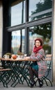 Happy girl sits in cafe on the street of Budapest Royalty Free Stock Photo